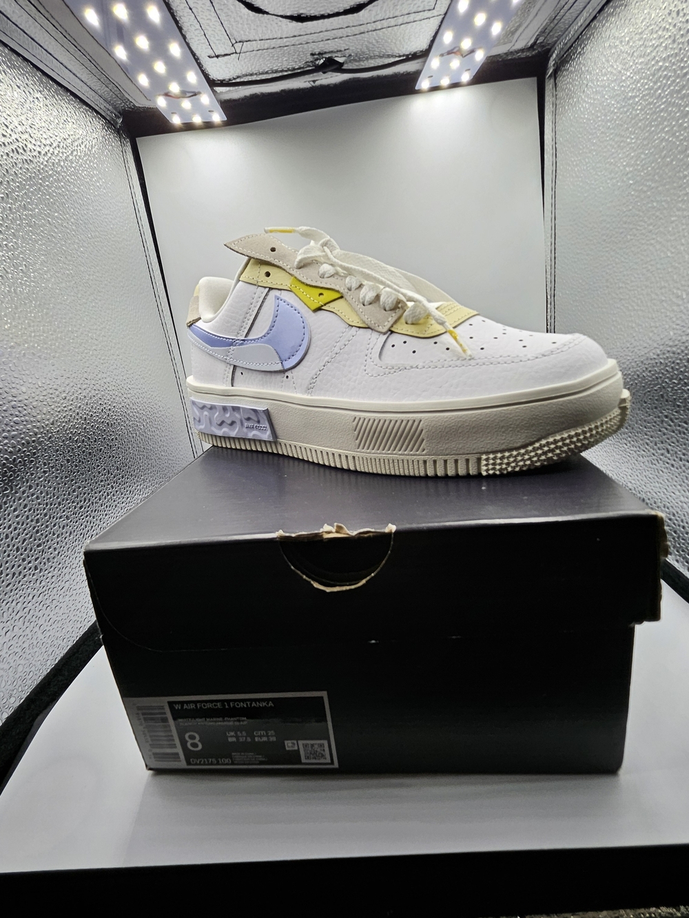 Nike Women’s White Sneakers with Pastel Blue and Soft Yellow Accents